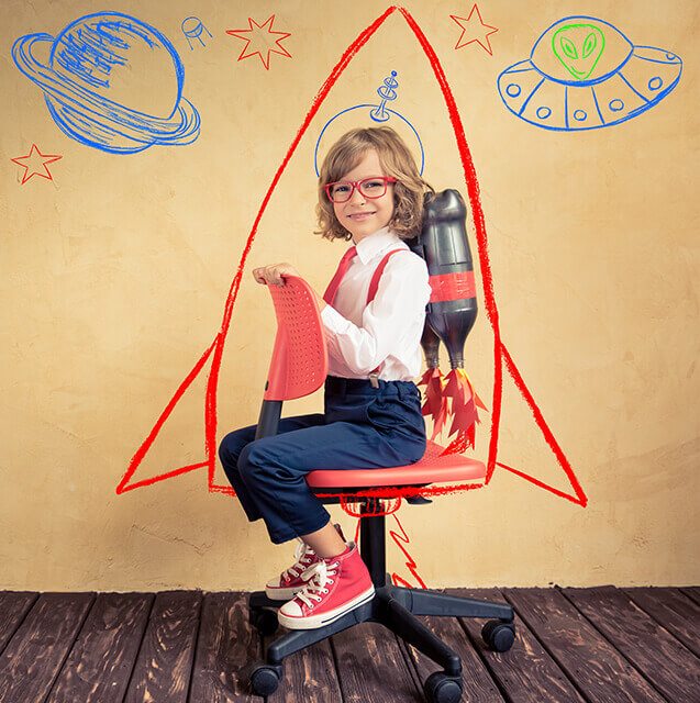 Happy child sitting on chair and rocket on wall drawn